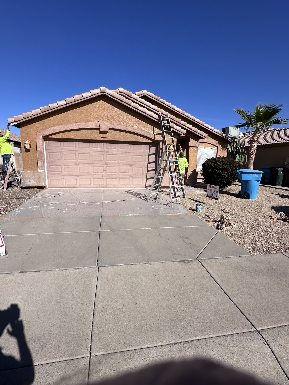J&S painters working on stucco, fascia, and trim details